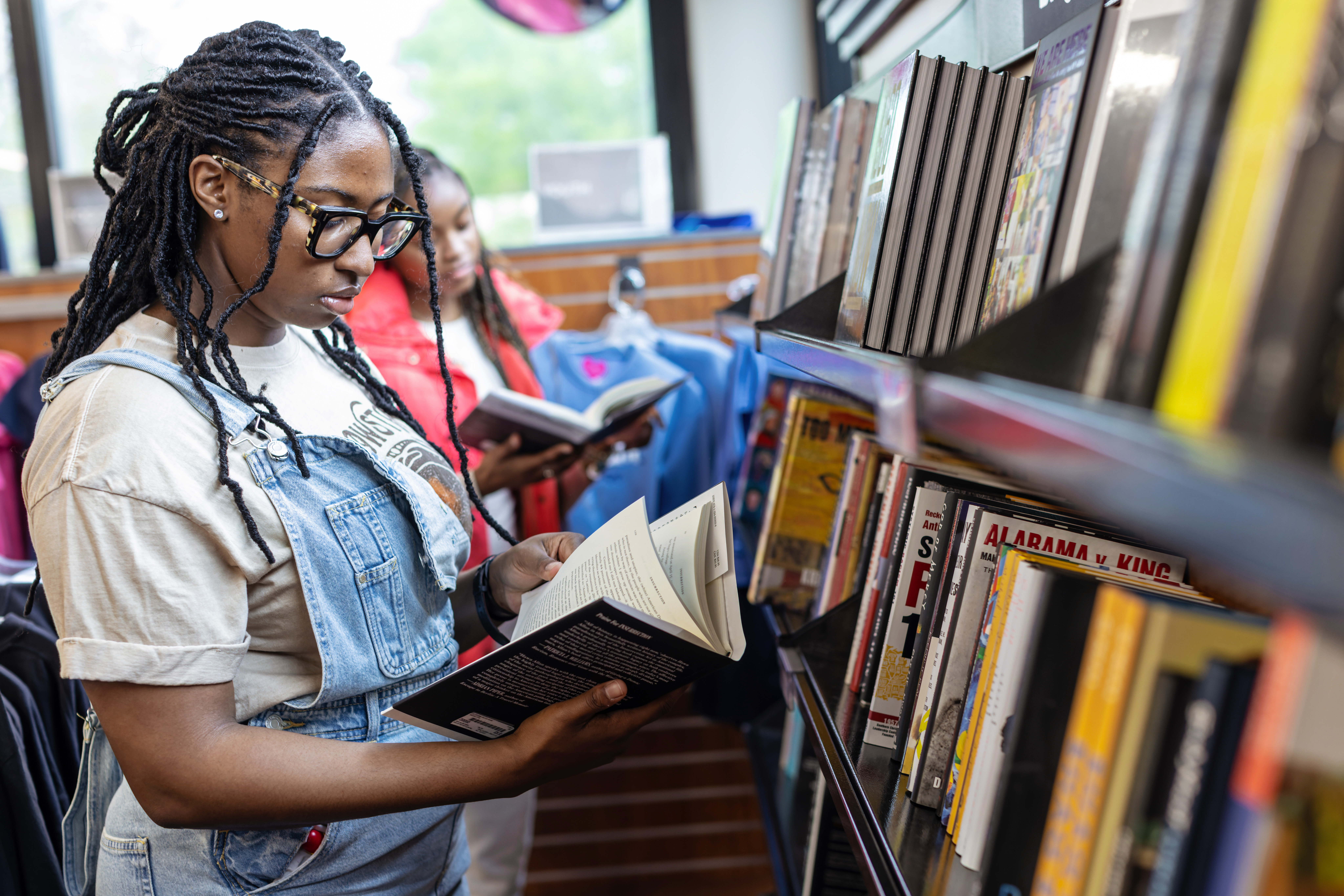spelman student looking at books in the library 
